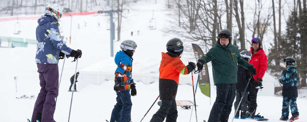 A family taking a ski lesson at The Highlands