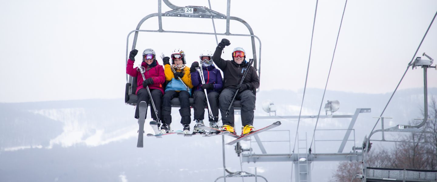A group on a ski lift at The Highlands